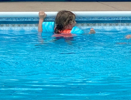 Neurodivergent child swimming in the pool