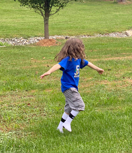 An autistic child spinning with joy. 