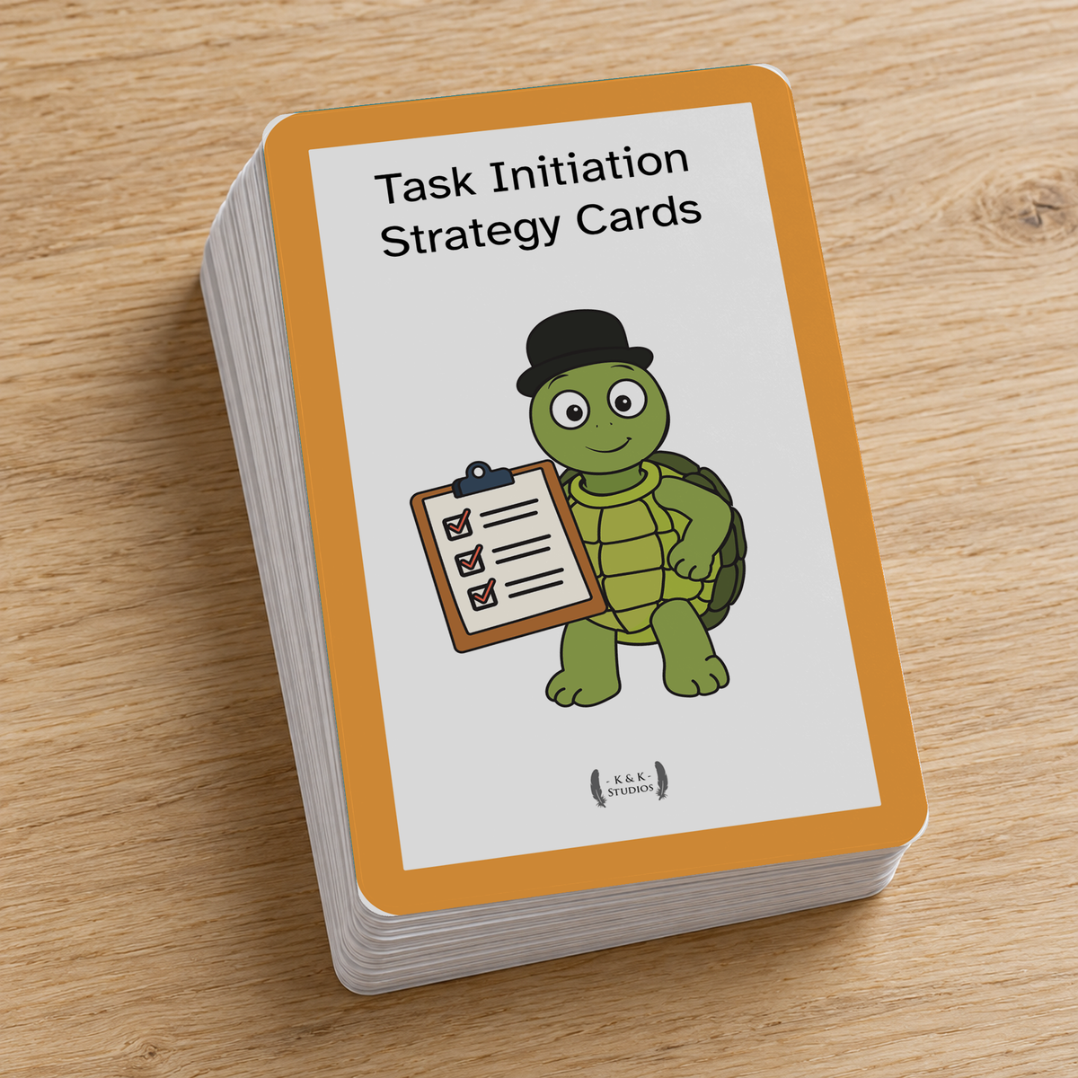 A deck of Task Initiation Strategy Cards shown as a stack on a light wood tabletop. The top card has an orange border, a white center, and a cartoon green turtle wearing a black bowler hat and holding a clipboard.